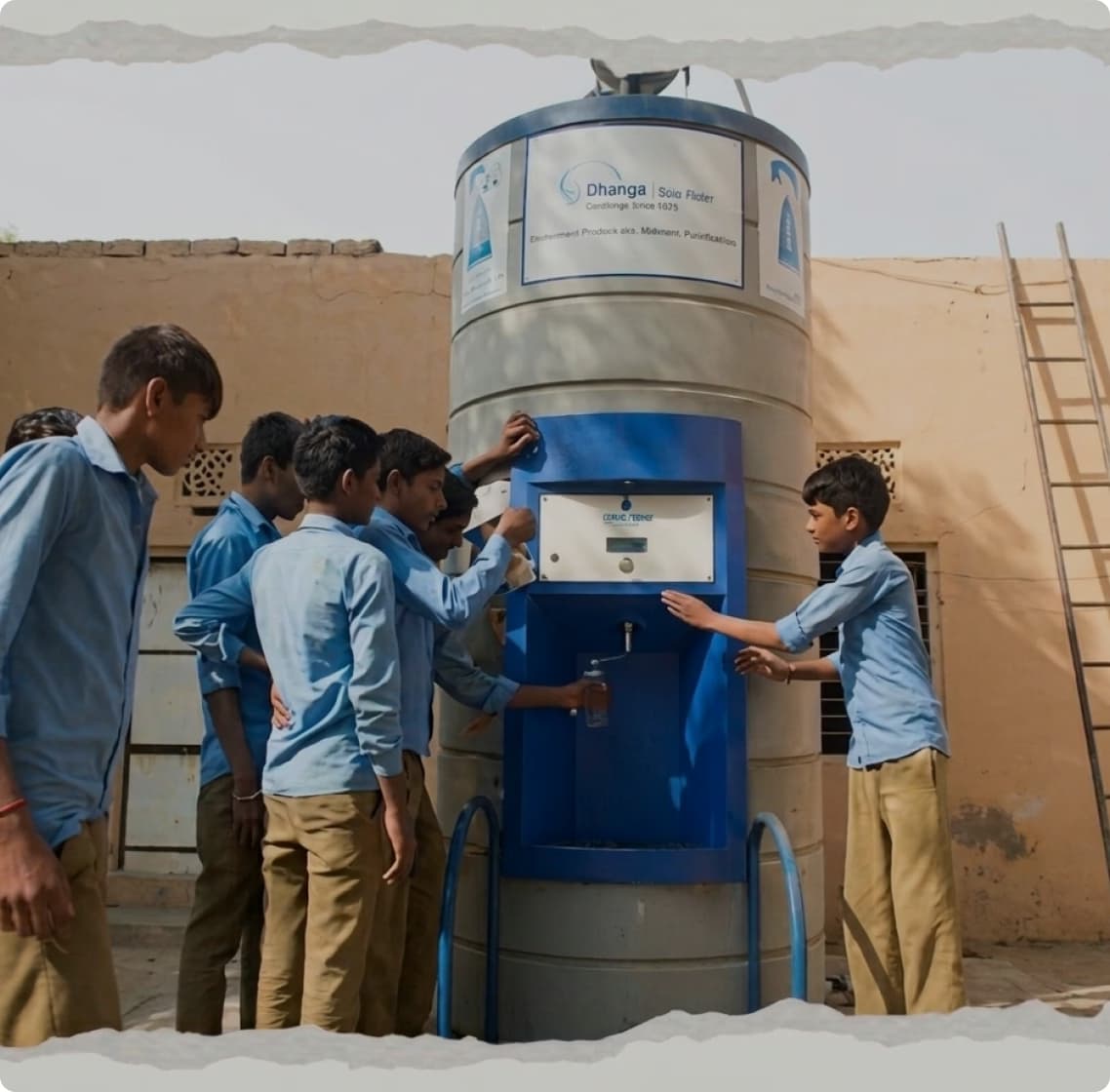 Students gathered around a water purification unit at school