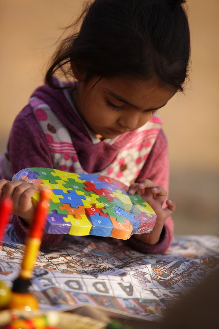 A child playing with colourful puzzle pieces